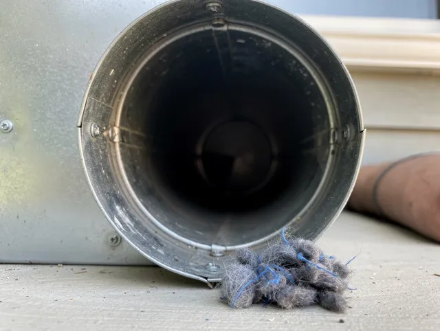 Davie Dryer Vent Cleaning technician using specialized equipment to clear severe dryer vent blockage in Davie